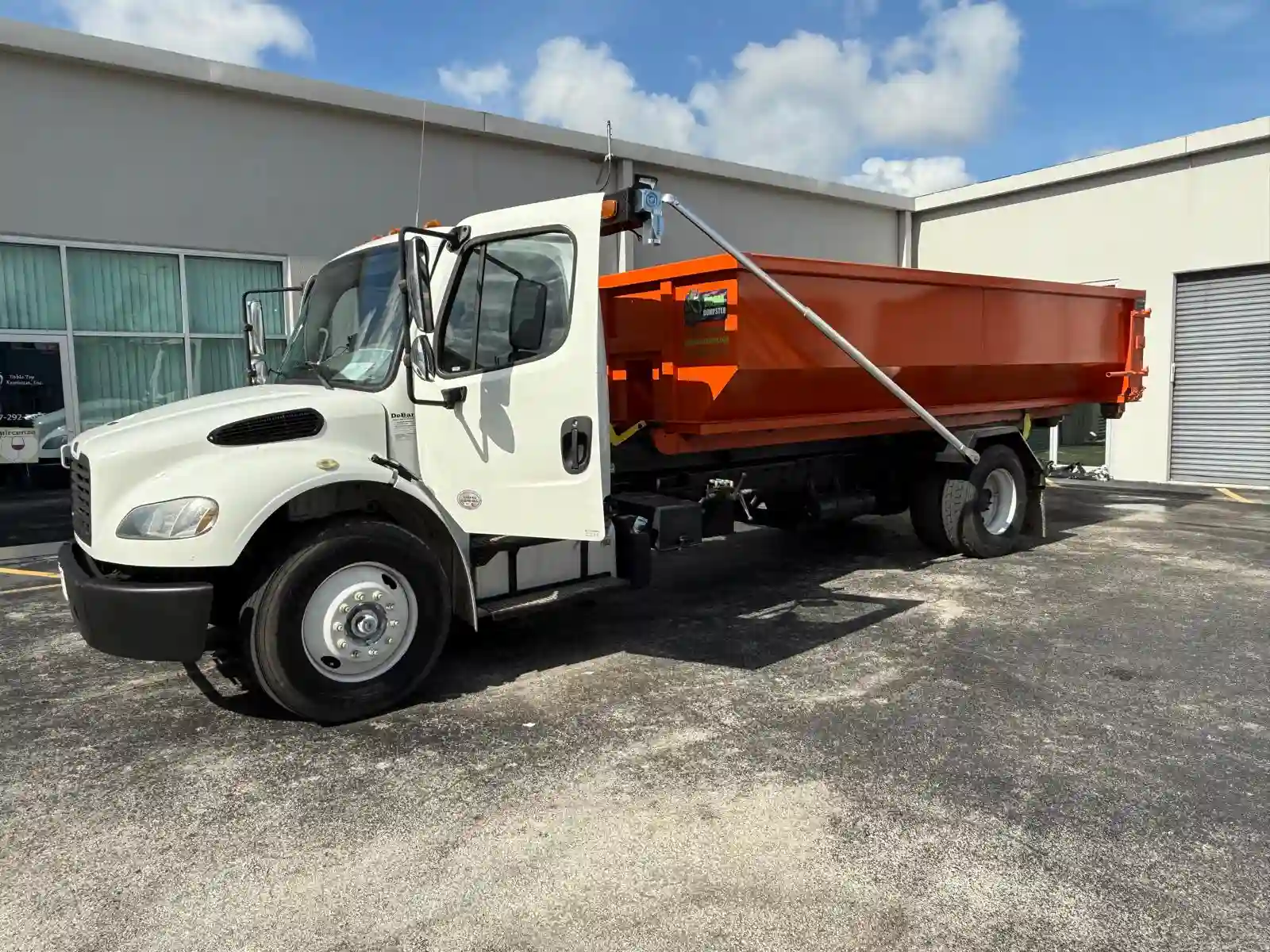 Dumpster Strong truck with orange dumpster in Orlando